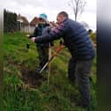 Freddie and Danny planting a crab apple tree on the Backfields in Whitby.