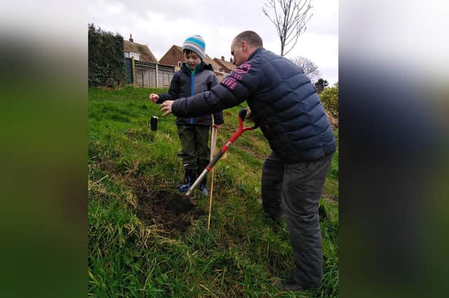 Freddie and Danny planting a crab apple tree on the Backfields in Whitby.