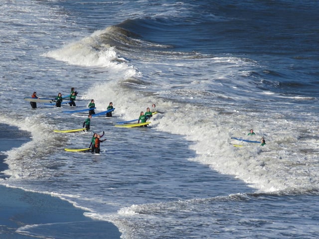 Surfers braving the waves in North Baby