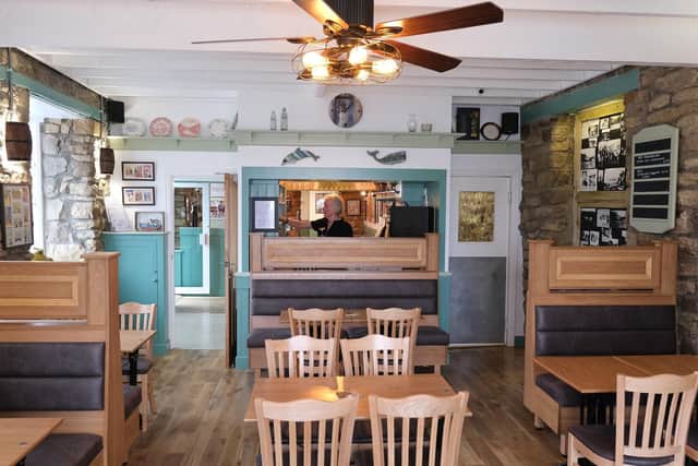 The interior of the pub has been completely replaced with high-back booth seating.