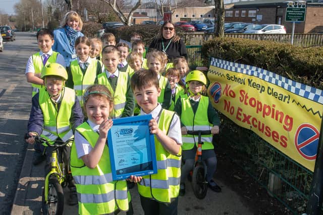 Pupils at Malton Primary Academy show off their award with Jackie Speakman, of the Sustainable Travel team, and Mandy Carpenter, who champions the Modeshift work at the school.