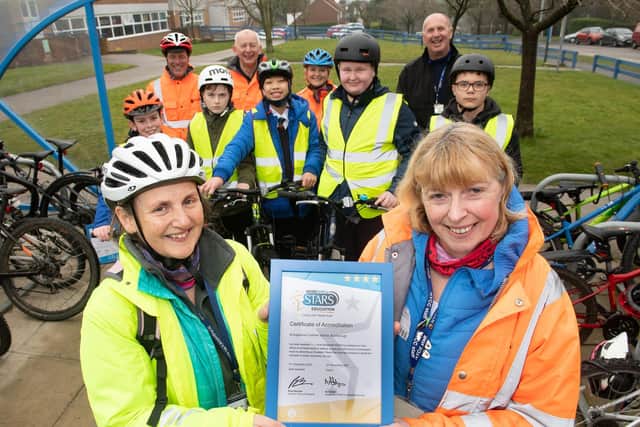 Pupils at a Bikeability session at St Augustine’s with (back, from left) Bikeability staff Keith Prichard, Ashley King, Alison Fewster and John Kiddle, and (front) Lisa Scott and Jackie Speakman.