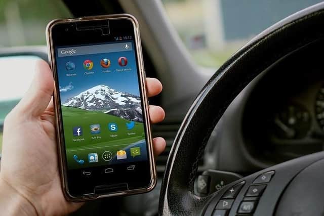 Anyone caught using their handheld device while driving could face a fine of up to £1,000 as well as six points on their licence or a full driving ban.