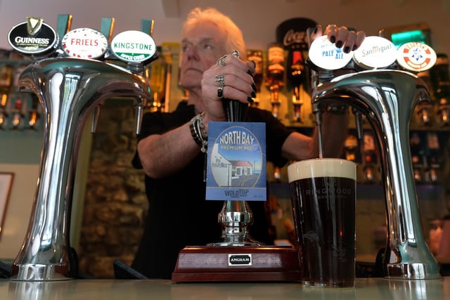 Landlord and owner Keith Dufton pulls a pint behind the new bar.