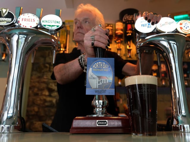 Landlord and owner Keith Dufton pulls a pint behind the new bar.