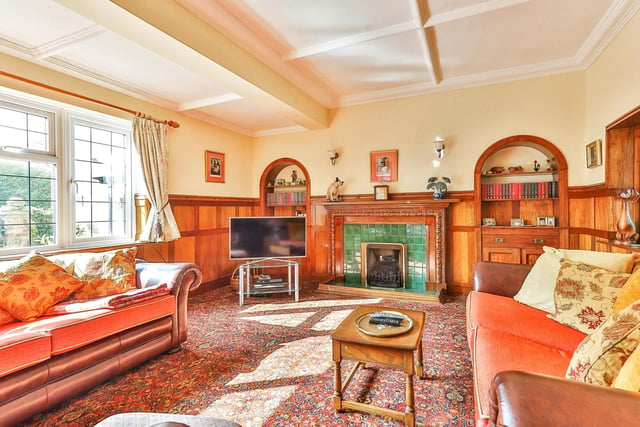 The lounge has a lovely feature fireplace and alcoves with built in cupboards.
