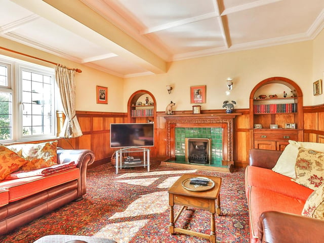 The lounge has a lovely feature fireplace and alcoves with built in cupboards.