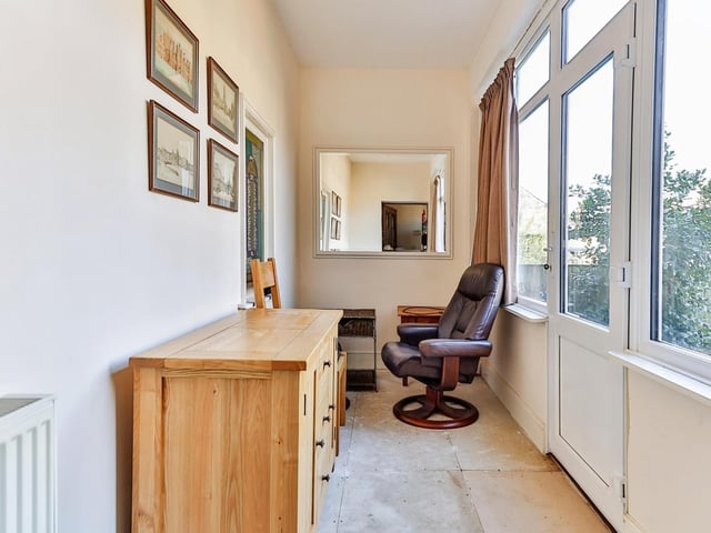 This room could serve a variety of purposes but is currently used as a study or office.