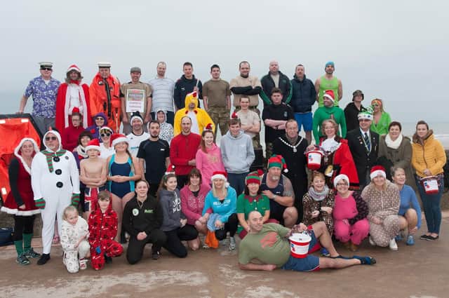 This excellent group photograph features the Bridlington Dip for Heroes event held on Boxing Day in 2014. Do you recognise any of the people ready to brave the waves in the picture? (nbfp-msh1452x035)
