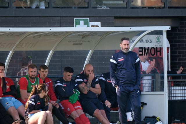 Scarborough Athletic manager Jono Greening and the rest of the bench look on