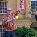 Scarborough Museums Trust’s learning assistant Bill Thomas and learning manager Christine Rostron with flower garlands