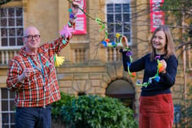 Scarborough Museums Trust’s learning assistant Bill Thomas and learning manager Christine Rostron with flower garlands