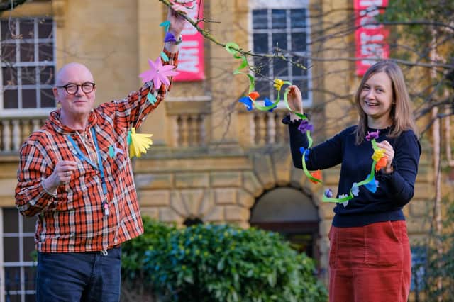 Scarborough Museums Trust’s learning assistant Bill Thomas and learning manager Christine Rostron with flower garlands