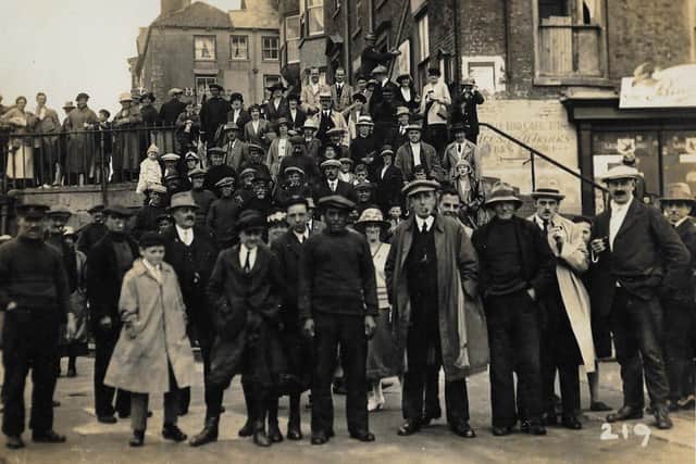 A group is pictured near the Blue Bird Cafe.