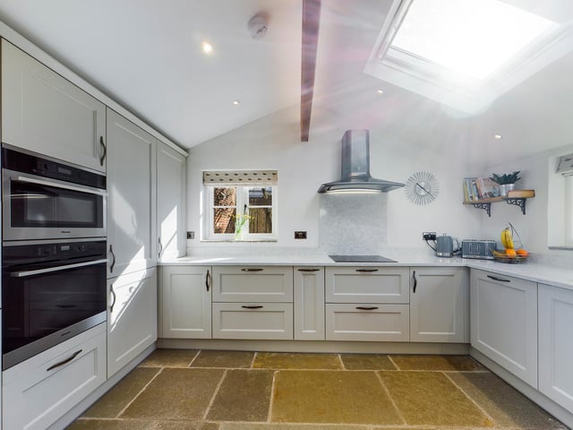 This modern kitchen is bright and appealing with integrated appliances.