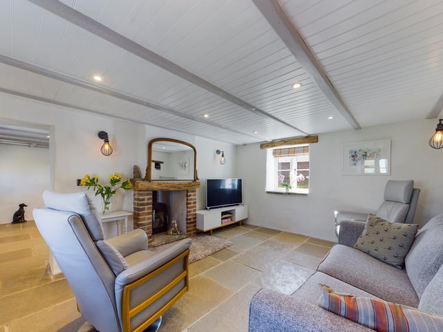 The brick and wood fireplace is a focal point within the lounge.