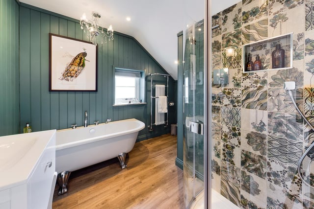 A free standing bath tub and a walk-in shower feature within this luxurious bathroom.