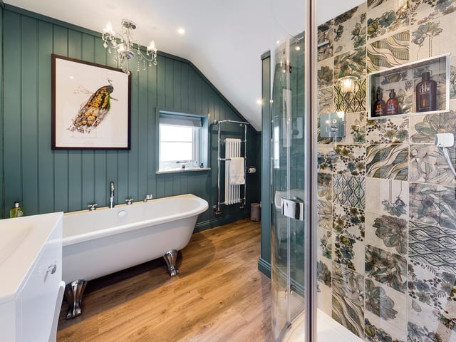 A free standing bath tub and a walk-in shower feature within this luxurious bathroom.
