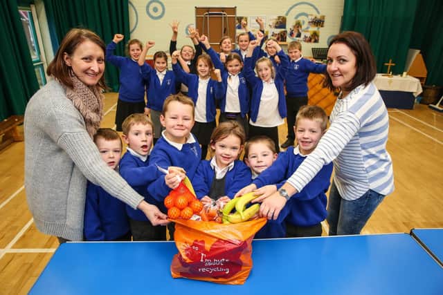 Liz Brooks and Sarah Arnold, members of the Friends of Lythe School, with some of the pupils who helped raise money for the minibus, ahead of a bag packing event at Sainsbury's in 2018.