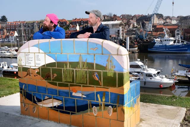 Ben Sadler and Phil Duckworth of Juneau Projects, with the new bench at Endeavour Wharf.