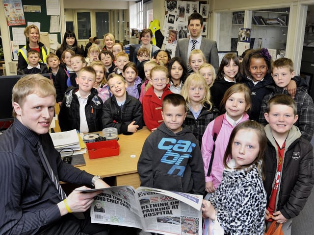 Scarborough Evening News reporter Steve Hugill, left, and digital editor Adam Meads, back right, show a group of children from Hinderwell Primary School, around the Evening News newsroom.