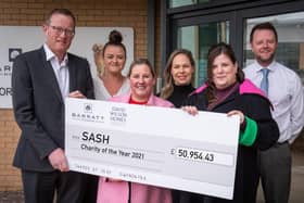 Daniel Smith, managing director of Barratt Developments Yorkshire East, presents the cheque for £50,954 to SASH representatives.