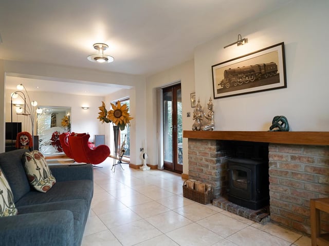 The lounge is both spacious and cosy, with doors leading outside.
