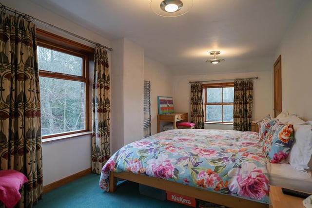 A spacious bedroom with large windows allowing plenty of natural light.