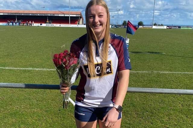 Steph Else is presented with a bunch of red roses after having been selected for the Red Roses U18s squad