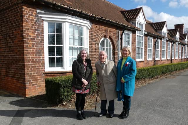 Dr Walsh and his daughters outside Malton School.