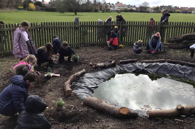 Children build a pond and plant trees at Our Lady and St Peter’s Catholic Primary School in Bridlington. Photo submitted