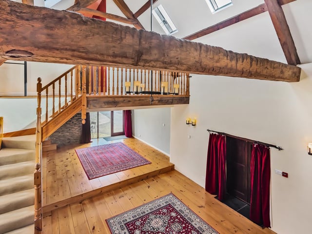 An impressive staircase branches out to two first floor galleried landings, from which can be found four bedrooms, three of which are doubles.