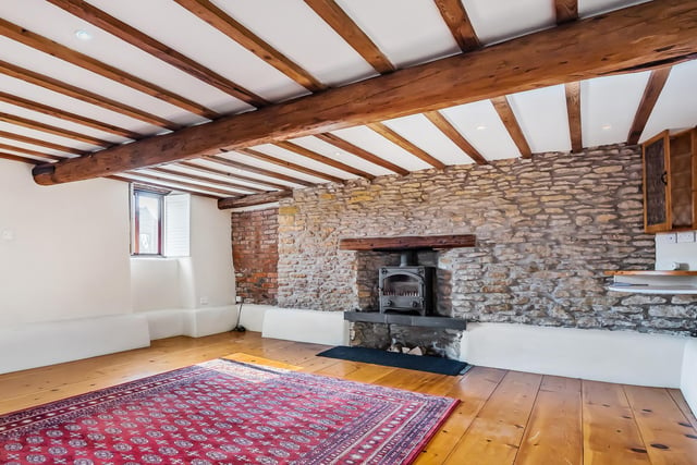The rustic character of the property is enhanced by hand-hewn wooden beams.