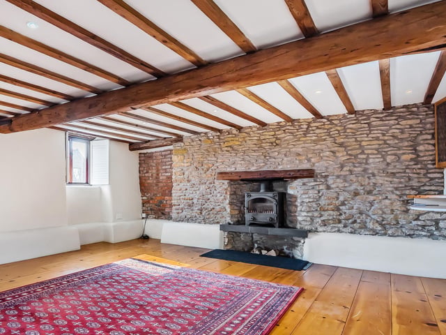 The rustic character of the property is enhanced by hand-hewn wooden beams.
