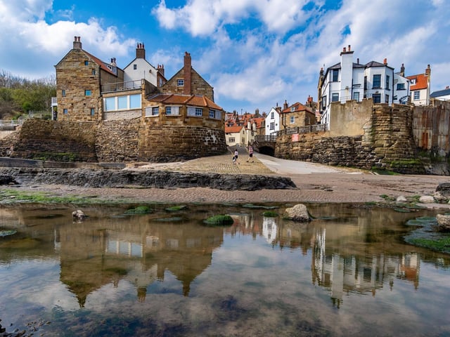 Picturesque yet rugged, peaceful yet heavy with stormy history, Robin Hood’s Bay is full of contradictions.
Today, the charming old fishing village belies a turbulent past where pirates, bandits and smugglers came out to play.
Seek out the local museum to swot up on local history, then turn your attention to its showstopper beach for fossil hunting, rock pooling and the obligatory sandcastle building.
