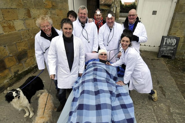 In 2013, Nags Head land lady Victoria Wilkinson, front right, had help from a group of  'doctors' with a patient's bed.