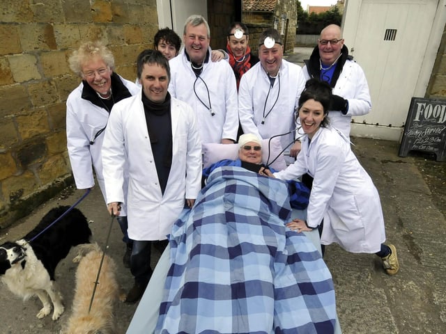 In 2013, Nags Head land lady Victoria Wilkinson, front right, had help from a group of  'doctors' with a patient's bed.
