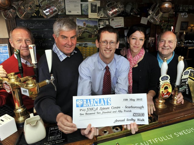 Handing over a cheque from Scalby Walk to Scarborough YMCA in 2012. From left, Jim Sloane, of Scalby Fair commitee, Alan Bruce, retiring organiser of the walk committee, Steve Marsh, executive director of the YMCA, Victoria Wilkinson, landlady of the Nag's Head pub, the walk's base, and Bob Gibbon, of the walk committee.