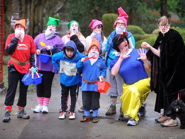 Fairytale walkers take a break to offer Snow Hite an apple in 2016.