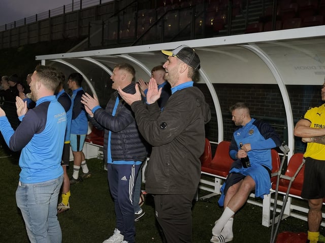 The Traf bench applaud the Senior Cup final win