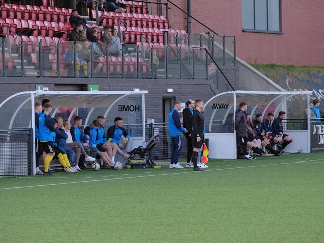 The two dug-outs during the Senior Cup final