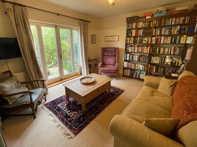 This adaptable room space could serve as a lounge, office, library or other, and has patio doors out to the garden.