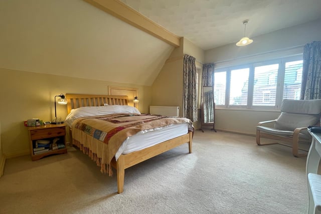 This double room is carpeted, with wide windows bringing in plenty of natural light.