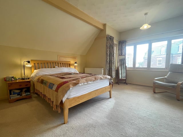 This double room is carpeted, with wide windows bringing in plenty of natural light.