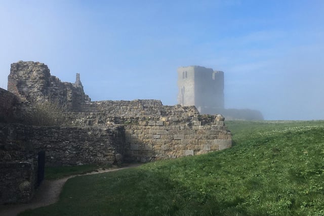 Scarborough Castle emerging from the sea fret.