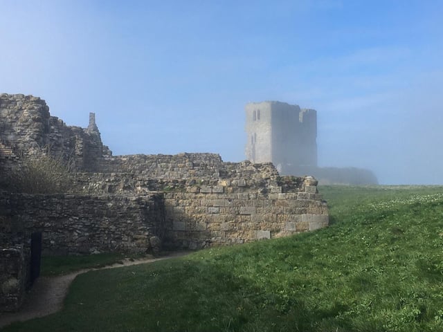 Scarborough Castle emerging from the sea fret.
