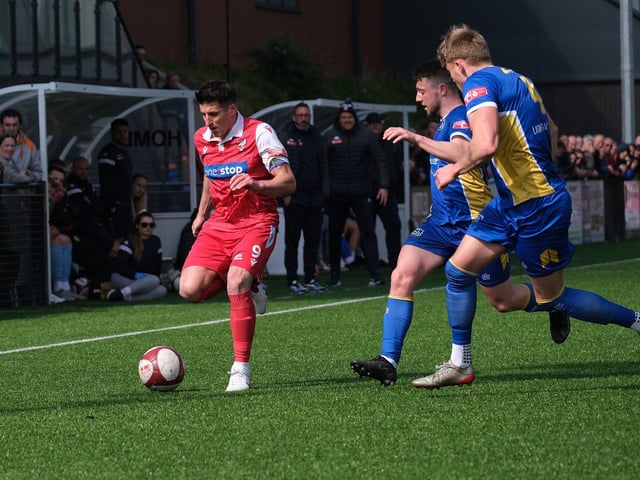 Michael Coulson is closed down by two Radcliffe players
