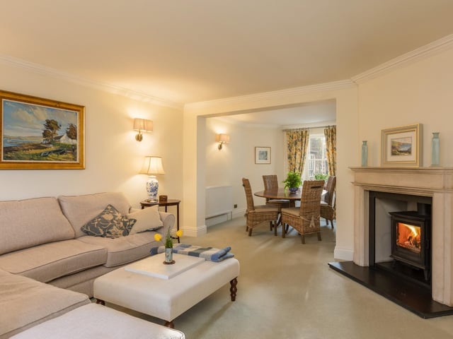 A feature fireplace in this reception room, with open link to the dining room.