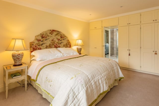 There's room for king size comfort in this double bedroom with fitted wardrobes.