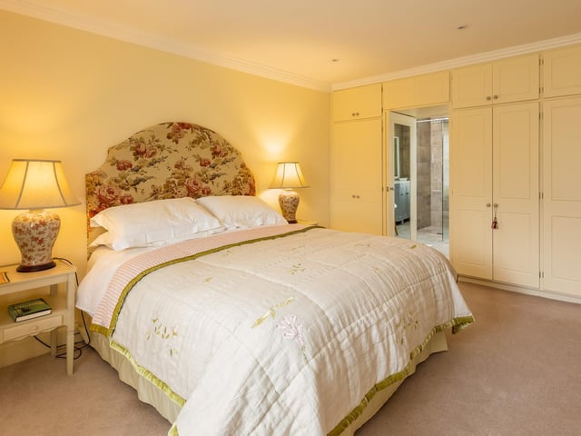 There's room for king size comfort in this double bedroom with fitted wardrobes.